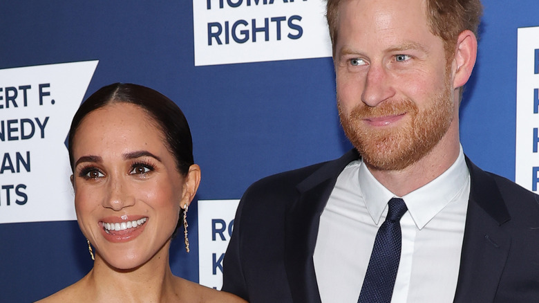 Meghan Markle and Prince Harry smiling at an event