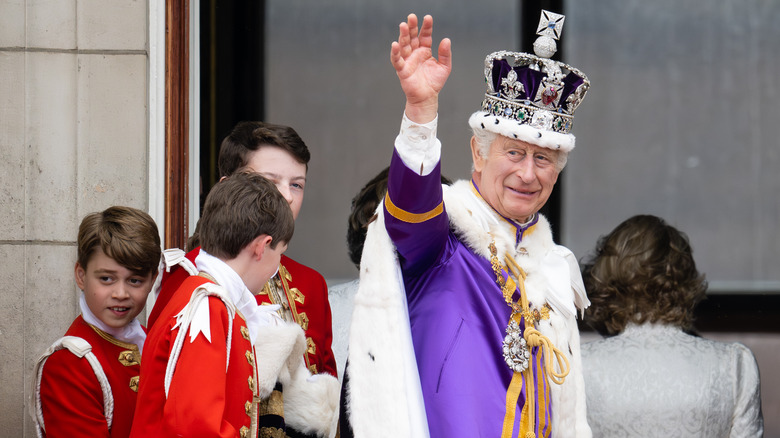 King Charles waving at Buckingham Palace