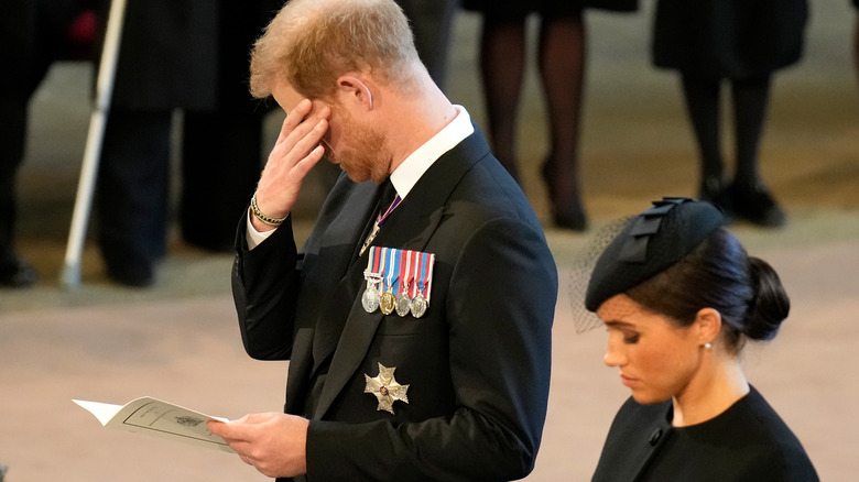 Prince Harry with Meghan Markle at queen's procession