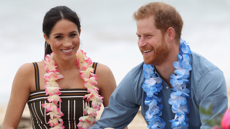 Meghan Markle and Prince Harry wearing leis in Australia