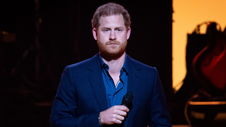 Prince Harry looks grumpy onstage