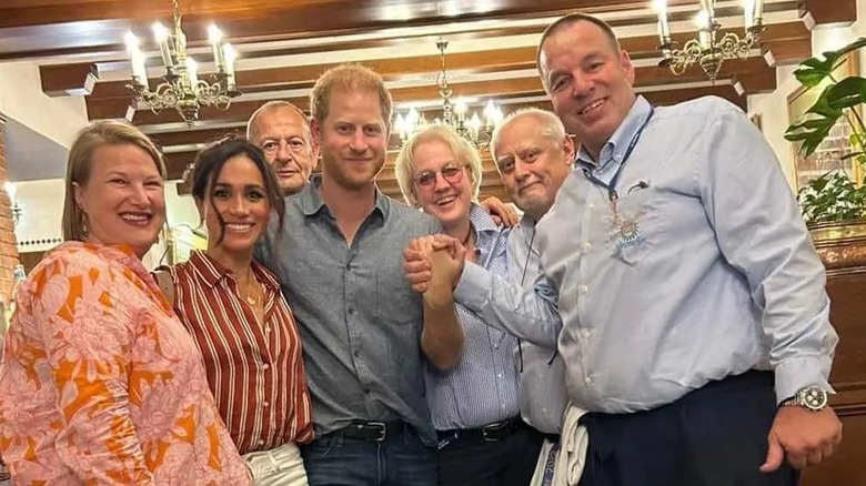 Meghan Markle and Prince Harry smiling in group photo