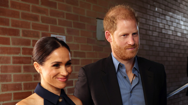 Meghan Markle and Prince Harry standing next to each other