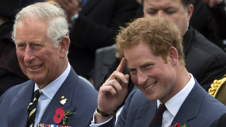 King Charles and Prince Harry smiling