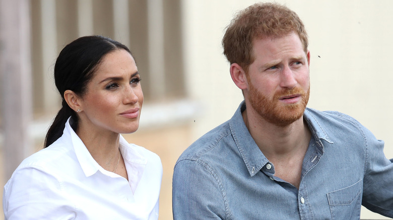 Meghan Markle and Prince Harry looking serious