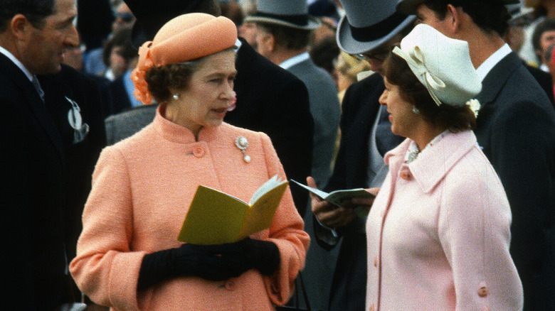 Queen Elizabeth talking to Princess Margaret