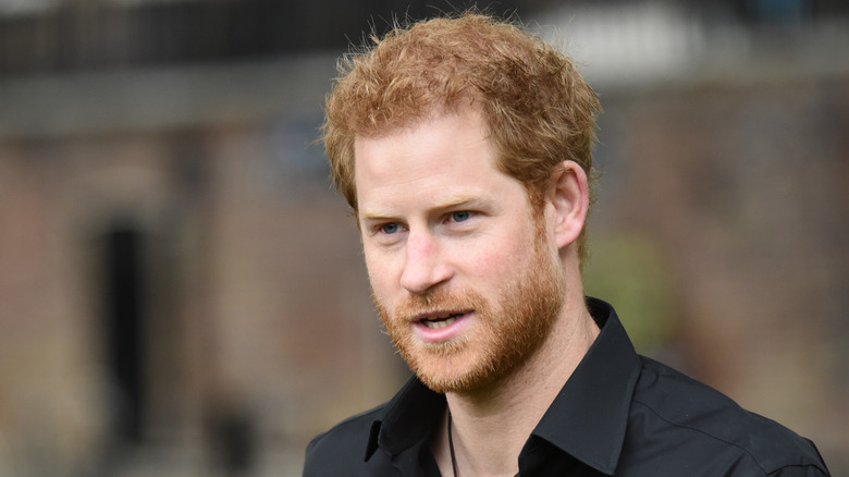 Prince Harry wears a black shirt