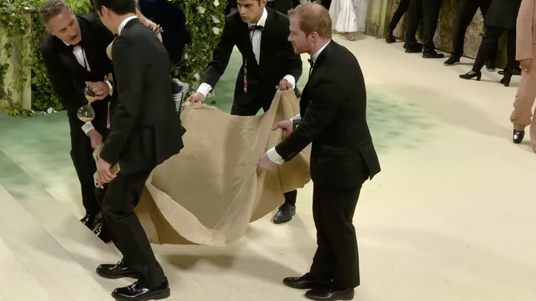 Prince Harry doppelganger holding dress train