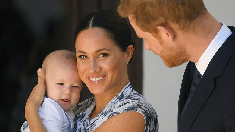 Prince Harry and Meghan Markle posing with son Archie 