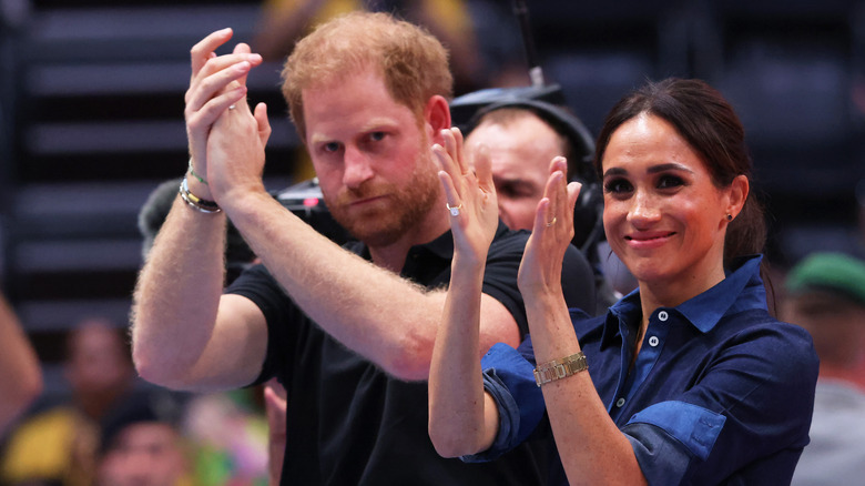 Prince Harry and Meghan Markle ominously clapping