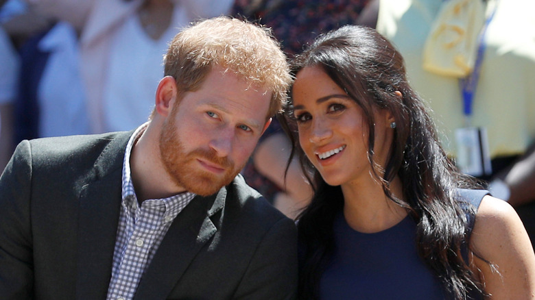 Prince Harry leans in to listen to Meghan Markle