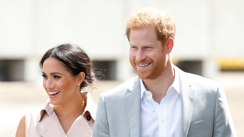 Meghan Markle and Prince Harry smiling at an event