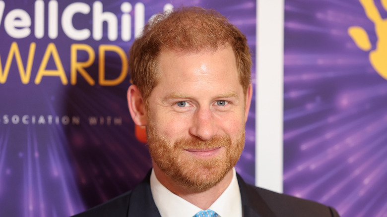 Prince Harry slightly smiling in a dark jacket