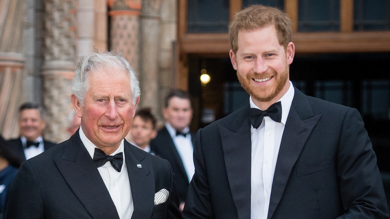 King Charles and Prince Harry posing together in matching suits