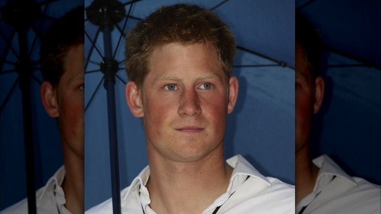 Prince Harry holding umbrella