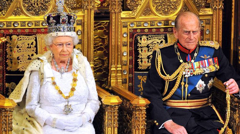 Prince Philip and Queen Elizabeth II sitting on thrones