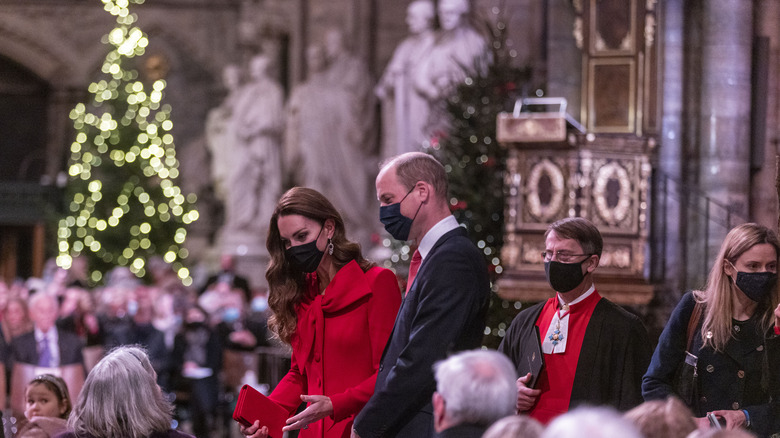 Prince William and Kate Middleton surrounded by a crowd