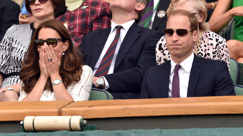 Princess Catherine covers her mouth next to husband Prince William