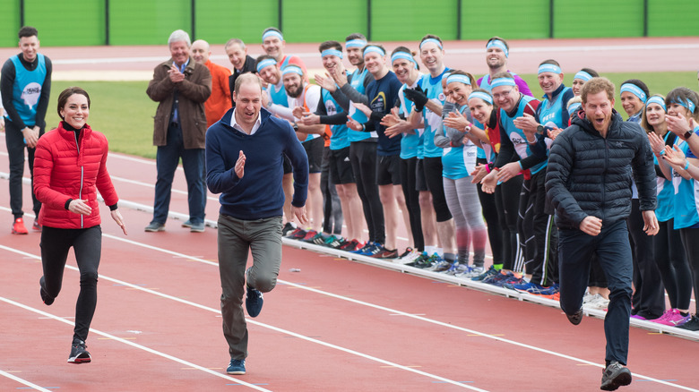 Prince William Princess Catherine and Prince Harry running on a track