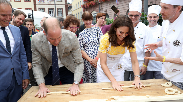 Prince William and Princess Catherine rolling pretzel dough