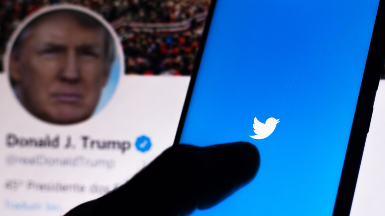 Donald Trump's Twitter account and person holding phone with Twitter open 