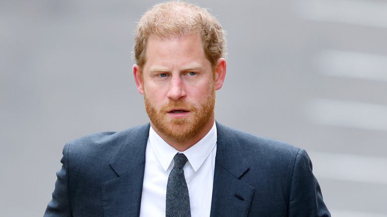 Prince Harry walking in a suit