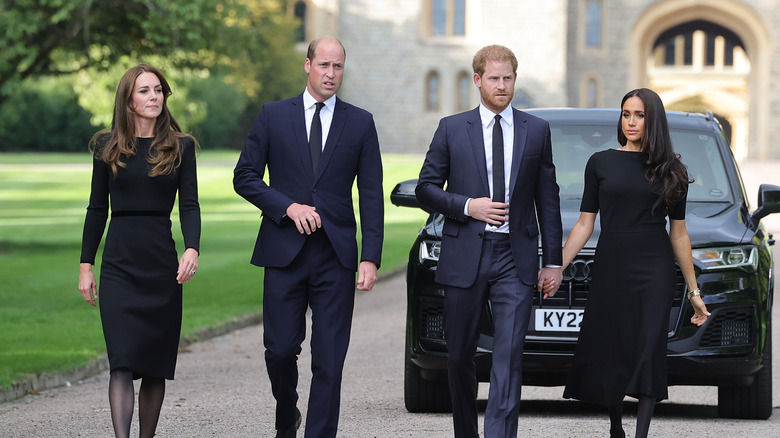 Kate Middleton, Prince William, Prince Harry, and Meghan Markle on walkabout outside Windsor Castle after Queen Elizabeth's death