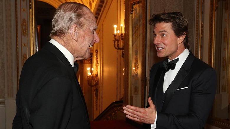 Prince Philip and Tom Cruise smiling and chatting