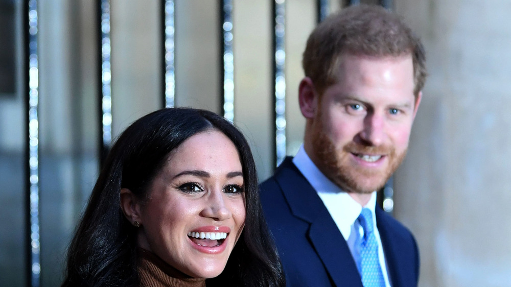 Meghan and Harry smile for photographers