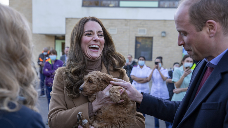 Prince William and Kate Middleton with a dog