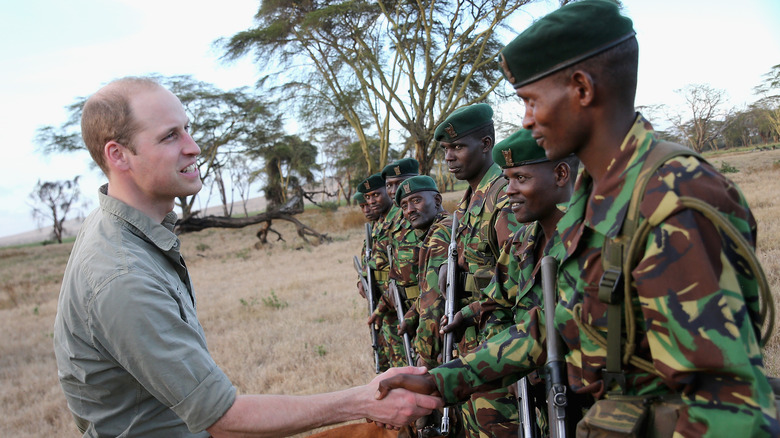 Prince William shake hands African wildlife rangers