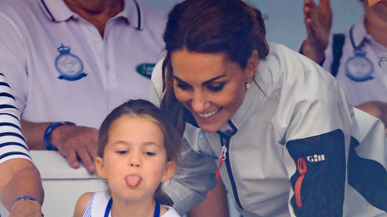 Princess Charlotte sticks her tongue out next to her mom, Kate Middleton