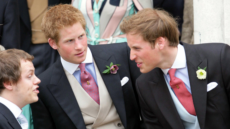 Prince William speaks to Tom Parker Bowles while Prince Harry watches