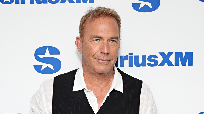 Kevin Costner wearing black vest