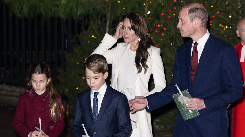 Prince William, Kate Middleton, and their kids walk past trees