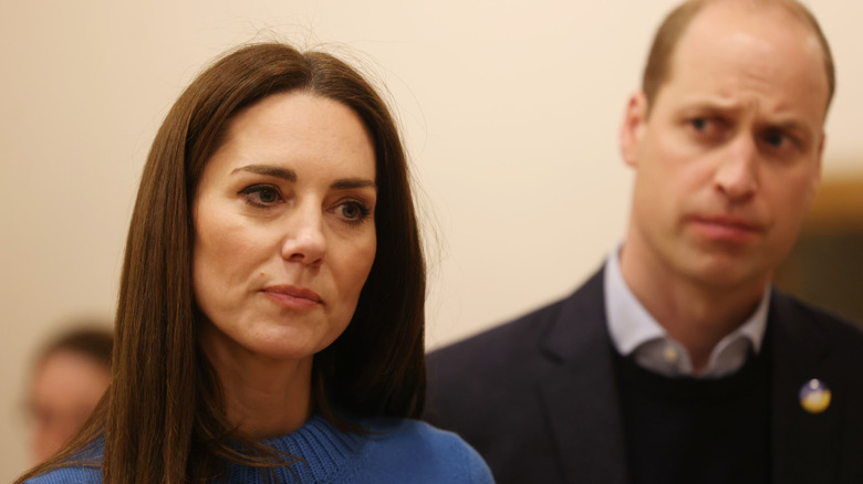 Prince William looking at Kate Middleton, both concerned in close-up