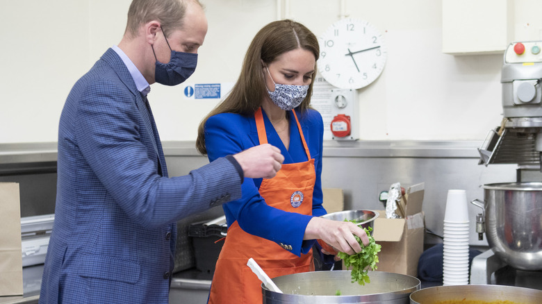 Prince William and Kate Middleton throw ingredients into a large pot