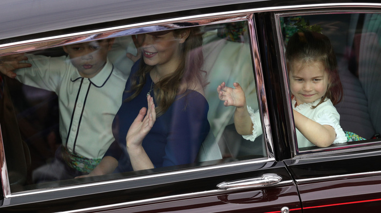 Prince Louis and Princess Charlotte waving from car