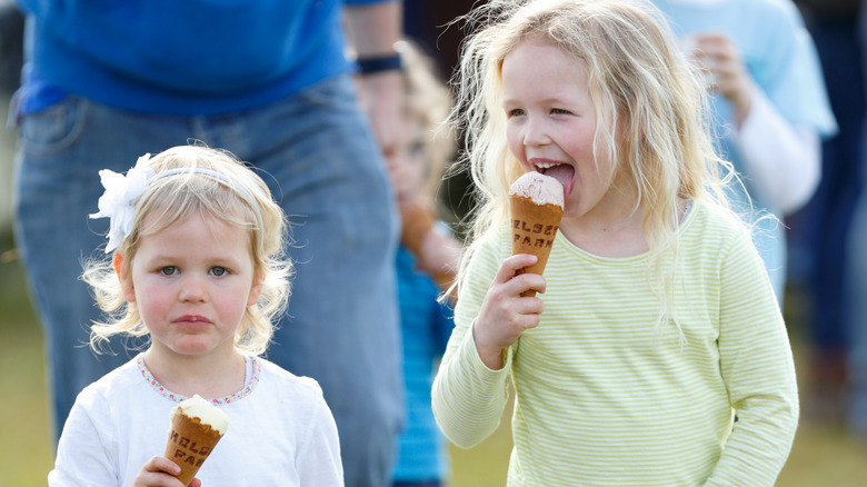 Savannah Phillips and Isla Phillips eating ice cream