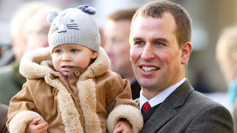 Peter Phillips holding daughter Isla