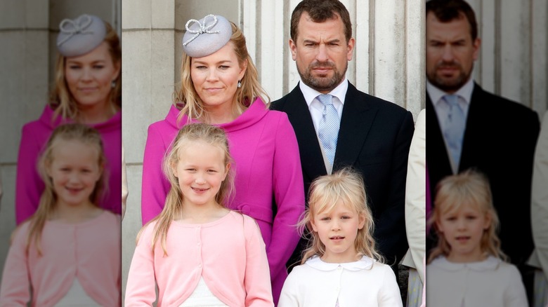 Autumn Kelly, Peter Phillips, Savannah Phillips, and Isla Phillips on balcony