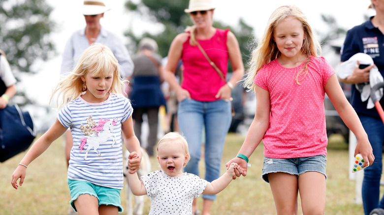 Savannah Phillips and Isla Phillips walking with Lena Tindall