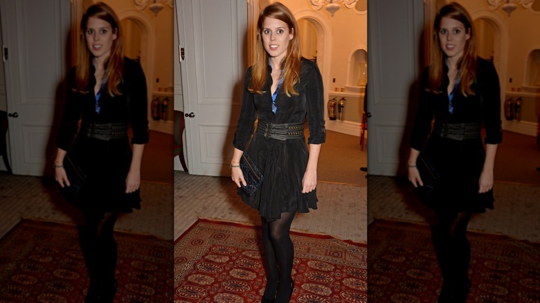 Princess Beatrice posing in a black dress