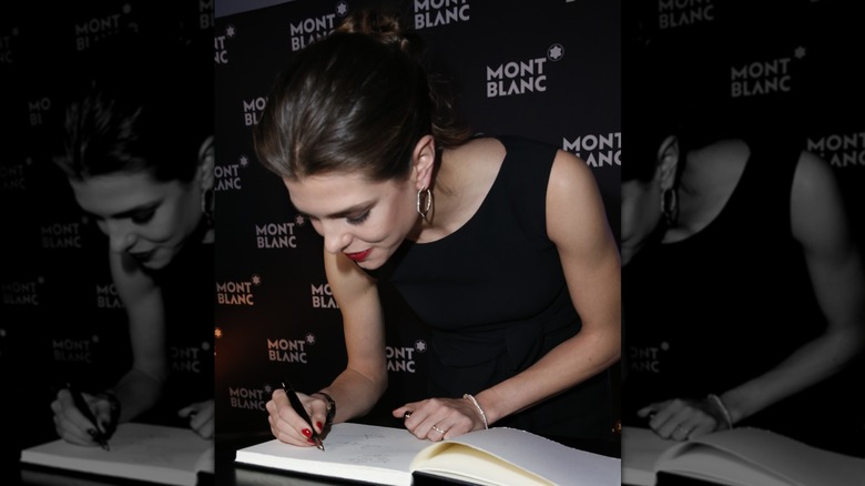 Charlotte Casiraghi signing a book for Montblanc