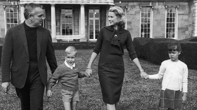 Grace Kelly walking with husband and kids