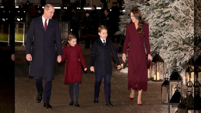 Princess Charlotte holding hands and walking with Prince William, Princess Catherine, and Prince George