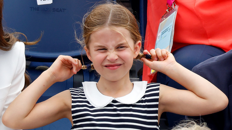 Princess Charlotte pulling braids scrunching face