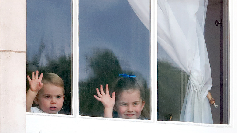 Princess Charlotte and Prince Louis waving from window