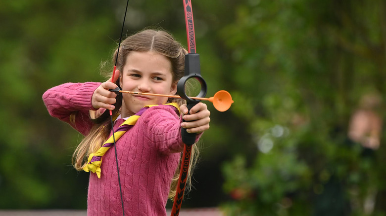 Princess Charlotte aiming bow and arrow