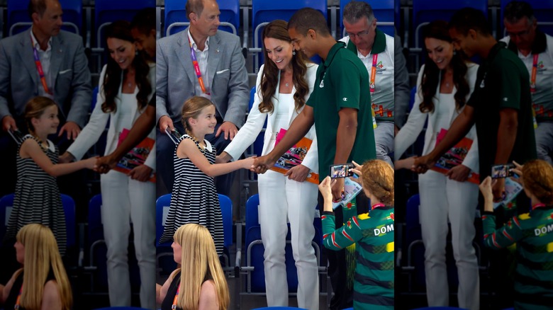 Princess Charlotte shaking athlete's hand at Commonwealth Games